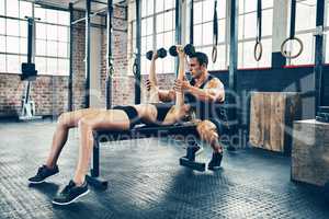 We belong together because we train to be strong together. a couple working out at the gym.