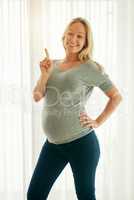 This is baby number one. a beautiful woman posing with her baby bump.