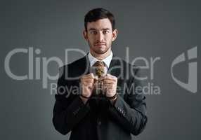 Dont let dishonest business practices hold you back in business. Studio portrait of a handcuffed businessman with a noose tied around his neck for a tie against a gray background.