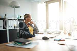 Carefully considering her options. a mature businesswoman looking thoughtful while sitting in her corporate office.