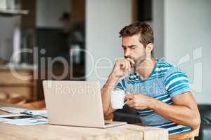 Hes got a lot to think about it. a handsome young male entrepreneur looking thoughtful while working from his home office.