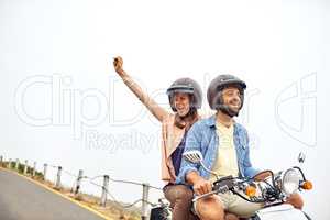 Enjoying unsurpassed freedom of movement. an adventurous couple out for a ride on a motorbike.