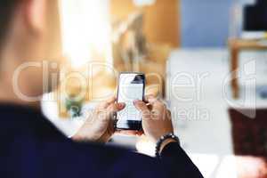 Available to talk business. a businessman using a mobile phone in a modern office.