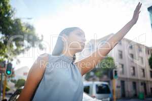 Travel with taxi, cab or uber in a city for business woman to commute to work, airport or hotel with transport. Young female worker stretching hand in town street, road or sidewalk for trip outside