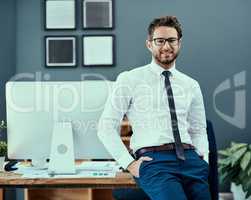 Positivity sure does lead to success. Portrait of a confident young businessman standing in an office.