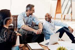 Some of the most productive meetings are informal ones. a group of businesspeople having a meeting in a modern office.