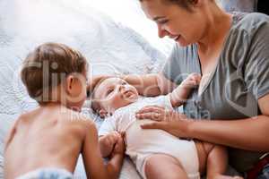 Big brother, meet baby brother. a young woman bonding with her two sons at home.