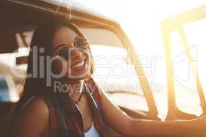 Summertime is travel time. an attractive young woman enjoying a road trip.