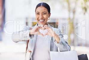 Shopping woman with love and heart sign or hand in an urban city street with retail bags. Professional fashion business female, customer and designer with self care or emoji hands, portrait and smile