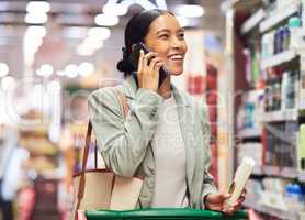 Supermarket store customer talking on phone shopping and searching local retail for healthy, wellness and personal hygiene shampoo. Smile and happy woman looking at routine grooming products for sale