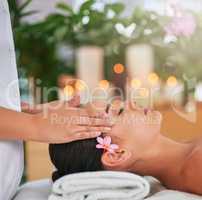 Just relax and unwind. an attractive young woman enjoying a head massage at a spa.