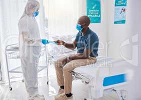 Black man talking to doctor, with covid mask and getting medical wellness advice at hospital or clinic. Expert, professional or healthcare worker helping patient, doing checkup and giving brochure