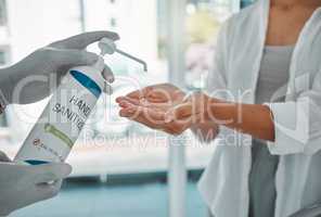 Sanitizer or sanitizing woman cleaning her hands to prevent the spread of covid at the airport. Closeup of a female using antibacterial disinfectant for coronavirus protection in a modern building