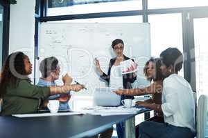 We could use some new ideas right now. a group of focussed businesspeople attending a colleagues presentation in the boardroom.