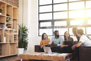 Idea generation. a group of young designers having a meeting in a modern office.