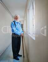 Its good to be a pensioner. Portrait of a happy senior man posing in the hallway of his nursing home.