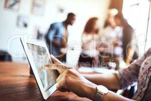 The internet can aid a businesses in achieving the perfect image. an unrecognizable woman using a digital tablet at the office.