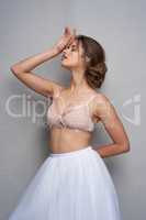 Do it with style. Portrait of a beautiful young woman posing in studio while wearing a bra and ballet skirt.