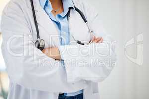 Medical healthcare doctor, woman worker or employee arms crossed standing confident with stethoscope in hospital. Leadership, work and wellness female staff manager nurse working in medicine office.