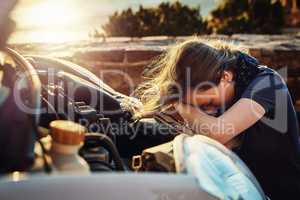 Both her and her car are going through a breakdown. a young woman looking upset after breaking down on the roadside.