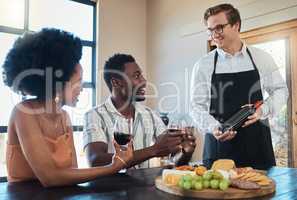 Hospitality industry, restaurant service and waiter showing wine to couple on romantic date, talking and looking happy. Lovers enjoying conversation with sommelier and celebrating their relationship