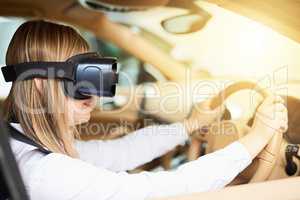 Seeing traffic with fresh eyes. a young businesswoman wearing a virtual reality headset while driving her car.