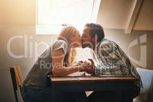 Your kisses are pure bliss. a young couple spending time together at a cafe.