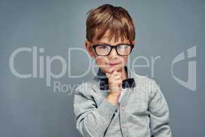 Nerd is the new cool. Studio portrait of a smartly dressed little boy posing confidently against a gray background.
