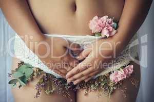 Protect your flower garden. High angle shot of an unidentifiable young woman with flowers growing out of her lace panties.