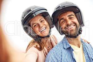 Helmets are on and so is our selfie game. an affectionate couple taking selfies outside.