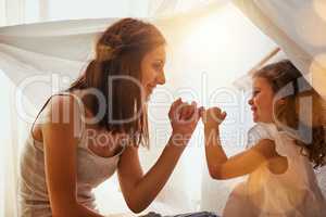 I pinky swear my dear. a mother and daughter coming together and making a pinky swear as a promise to one another.