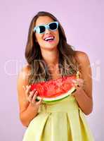 Its vital for your health and happiness. Studio shot of a beautiful woman holding a watermelon against a pink background.