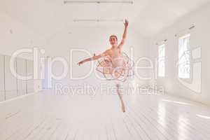 Ballet, passion and art performance with ballerina express freedom with classic, elegant move in a dance studio. Free female practicing a routine, jumping with high energy and perfect posture