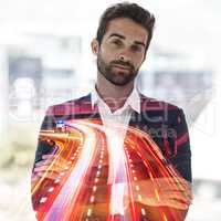 Living life in the fast lane. Cropped portrait of a handsome young businessman superimposed on a cityscape.