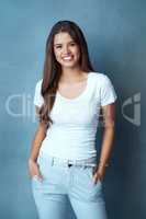 To be beautiful, be you. Studio shot of an attractive young woman posing against a blue background.