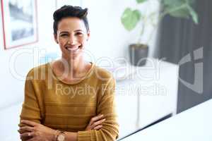 Confidence is my secret. Cropped portrait of a confident and attractive young businesswoman standing with her arms crossed in an office.