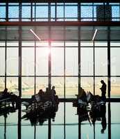 Coming and going. a group of unidentifiable travelers in the waiting area of an airport.