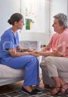 Ill always be around to assist. a nurse holding a senior womans hands in comfort.