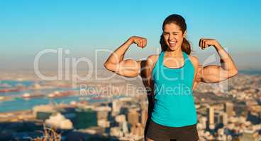 Showing off her guns. Cropped portrait of a young woman standing in front of her boyfriend whos flexing his muscles.