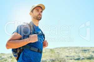 Setting off to reach greater heights. a young man out on a hike.