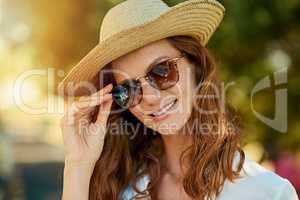 Style thats summer ready. an attractive young woman enjoying a summers day outdoors.