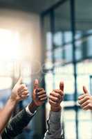 Keep up the awesome work. a group of unrecognizable businesspeople gesturing thumbs up.