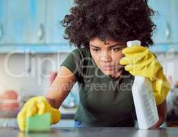 I missed a spot. an attractive young woman with yellow gloves cleaning her home.