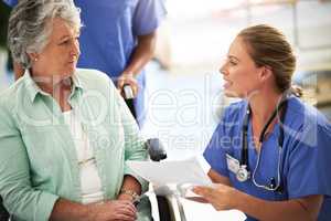 Experience you can trust. a doctor discussing treatments with a senior woman sitting in wheelchair in a hospital.