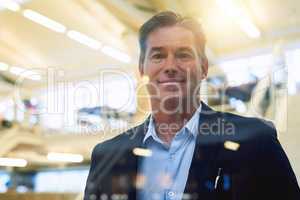 Confidence is my greatest strength. Portrait of a well-dressed businessman posing confidently in the office.