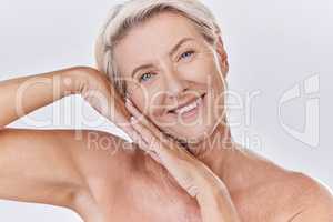 Skincare, clean and happy senior woman face resting on hands in a studio portrait. Elderly beauty skin care model posing or showing bedtime routine for perfect, healthy looking or wrinkle free aging