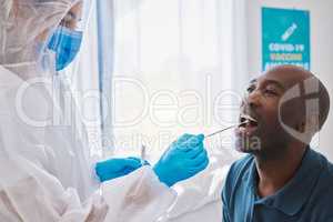 Doctor, healthcare and covid test using swab in mouth of a patient to collect specimen at testing center. Medical professional in hazmat suit for hygiene while working with coronavirus in a hospital