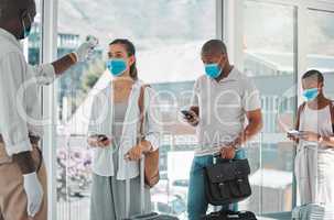 Covid, travel and healthcare worker testing the temperature of people to board a flight at an airport. A nurse, health and safety with travelers in masks getting tested for corona to get on a plane.