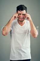 Men do cry and thats okay. Studio shot of a casual young man posing against a grey background.