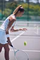 Female tennis player with ball and racket gear in a tournament match or fun outdoor hobby activity. Sports, active and fit woman preparing to serve opponent during a competitive or training exercise